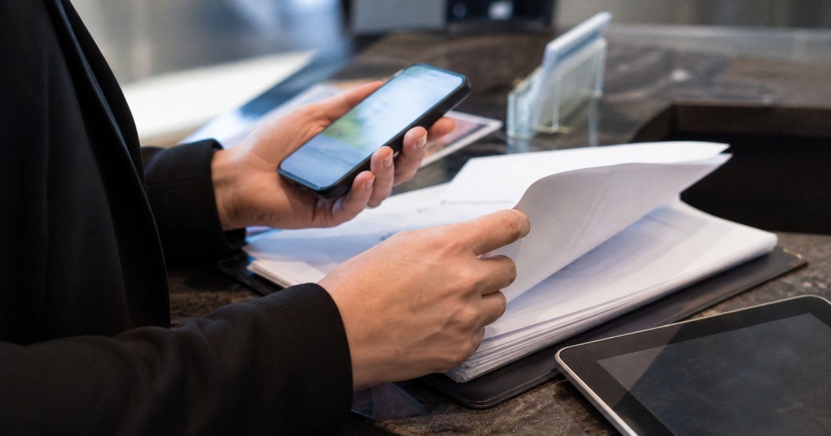 Riesgos IA generativa datos clientes pymes 20260827 realista Persona revisando documentos y telefono en una pyme para proteger datos al usar IA generativa